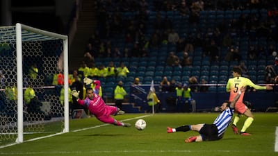 Manchester City goalkeeper Claudio Bravo attempts to stop a shot from Wednesday attacker Steven Fletcher. EPA