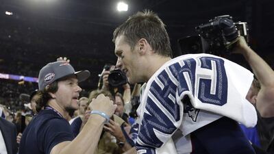 New England Patriots quarterback Tom Brady, right, celebrates with actor Mark Wahlberg after the NFL Super Bowl XLIX football game against the Seattle Seahawks. The Patriots won 28-24. Ben Margot / AP photo