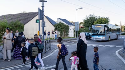 Schoolchildren and parents arrive at the Bois de l'Etang school for the start of the new school year in La Verriere, west of Paris. EPA