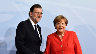 German chancellor greets Spain's Prime Minister Mariano Rajoy. John MacDougall / AFP Photo