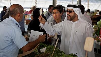 Dr Hashim Al Nuaimi, head of consumer protection at the Ministry of Economy, inspects fresh produce and its prices at the fruit and vegetable market at Port Zayed in Abu Dhabi yesterday.