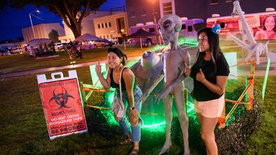 People take pictures at the Roswell festival. AFP