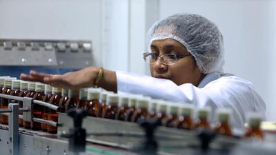 Bottles are packed by a worker at Julphar facility in Ras Al Khaimah. The company narrowed losses for the second quarter on the back of higher revenue and lower expenses. Pawan Singh / The National