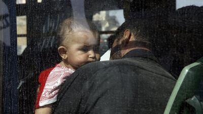 According to media reports, Syrian government buses and Red Crescent ambulances arrived in Daraya to transport some 4,000 people, both families and gunmen, to government shelters. Youssef Badawi/EPA