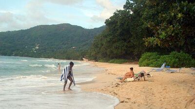 Tourists relax on a beach in Beau Vallon, Seychelles. The rising sea level due to global warming is taking a bite out of the Indian Ocean nation´s beaches, the number one tourist attraction.