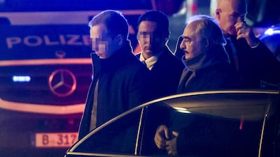 Field Marshal Khalifa Haftar is surrounded by security personnel as he gets out of his car upon his arrival at his hotel in Berlin on the eve of a peace conference on Libya to be held at the Chancellery. AFP