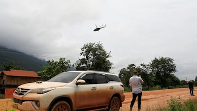 A military helicopter flies near flooded areas in Attapeu province, Laos. Reuters