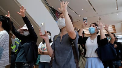 Protesters gesture with five fingers, signifying the "Five demands - not one less" in a shopping mall during a protest in Hong Kong. Protesters in Hong Kong got its government to withdraw extradition legislation last year, but now they're getting a more dreaded national security law. And the message from Beijing is that protest is futile. AP Photo