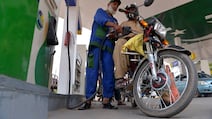 A worker fills the tank of a customer's motorcycle at a petrol station in Peshawar, Pakistan. Prices for distillates – diesel and jet fuel – have reached alarming heights in some markets. EPA