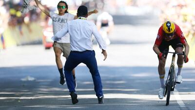 A protester wearing a t-shirt that reads 'Israel out of the tour' runs onto the road near the finish line as Jonas Abrahamsen is seen on his way to winning stage 11 of the Tour de France. Reuters