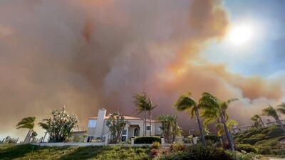 Smoke from the wildfire hangs over a residential area in Laguna Niguel. Reuters