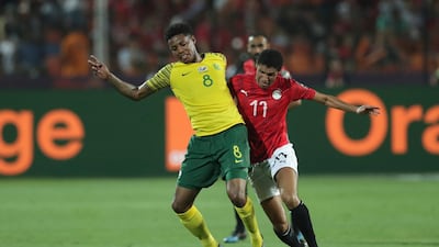 South Africa's Bongani Zungu, left, tussles for the ball with Egypt's Mohamed Elneny. AP Photo