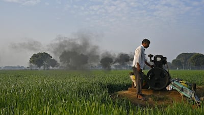 A man turns on a water pump at a farm in the district of Palwal in India's Haryana state on January 12, 2018. Anindito Mukherjee / Bloomberg