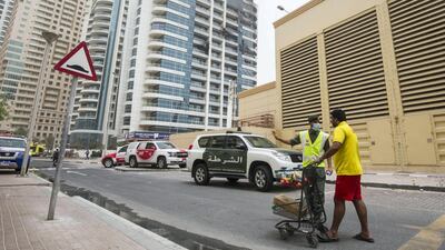 A resident giving food to the a civil defence officer during the aftermath of the fire. Leslie Pableo for The National