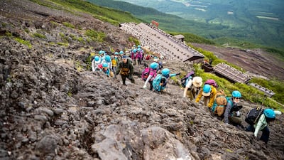 Hikers climb the steep slope of Mount Fuji in Japan. AFP