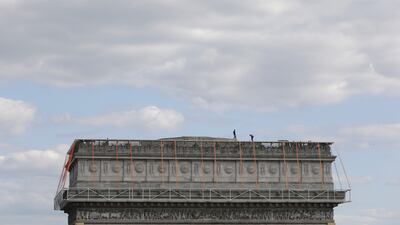 The Arc de Triomphe will be covered with fabric in silvery blue, and of red rope of the same fabric. AP