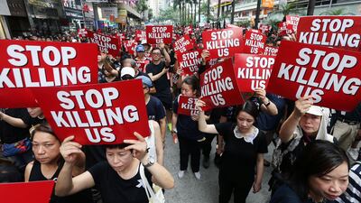 Protesters hold placards as they attend a demonstration demanding Hong Kong's leaders to step down and withdraw the extradition bill, in Hong Kong, China. Reuters
