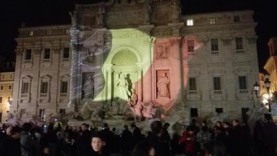 The flag is projected onto the Trevi Fountain, as people gather to pay tribute to the victims of the Brussels terror attacks, in Rome, Italy. Giancarlo Gambalonga / EPA