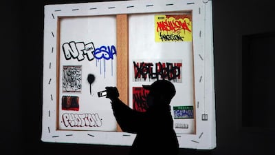 A person takes a photo during the opening of Superchief Gallery NFT, a physical gallery dedicated exclusively to non-fungible tokens artwork in New York. Photo: AFP