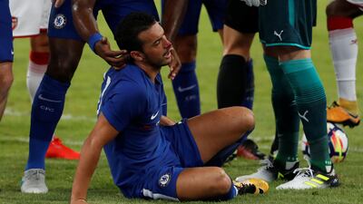 Chelsea's Pedro receives medical attention after colliding with Arsenal's David Ospina. Damir Sagolj / Reuters