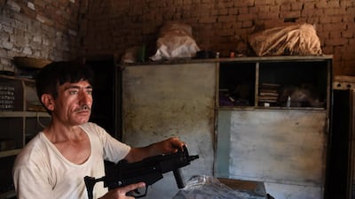 Pakistani gunsmith Khitab Gul tests a gun near a workshop in the tribal area of Darra Adamkhel, some 35 kilometres south of Peshawar. A Majeed/AFP