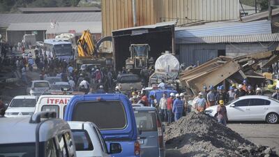Search and rescue teams and officials are seen around a coal mine where miners are trapped inside. Ihlas / Yilmaz Saripinar / Reuters
