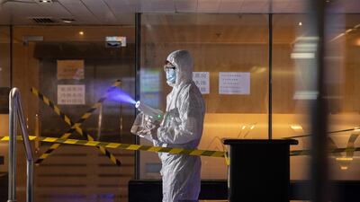 A worker in protective gear sprays disinfectant in a spa facility on the eve of its reopening day in Hong Kong, China. EPA