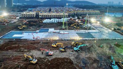 Excavators and workers are seen at the construction site where the new Huoshenshan Hospital is being built to treat patients of a new coronavirus on the outskirts of Wuhan, China. Reuters