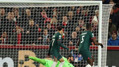 Liverpool goalkeeper Alisson Becker cannot stop Ibrahima Konate scoring an own goal. AFP