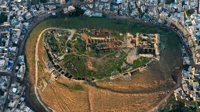 This aerial photograph shows a view of the citadel of Harem, perched on a hill overlooking the city of the same name, on the border with Turkey in the rebel-held northern countryside of Syria's northwestern Idlib province. Fierce battles took place between Syrian rebels and regime forces in Harem in 2012, during which heavy damage was inflicted on the originally Byzantine citadel. AFP