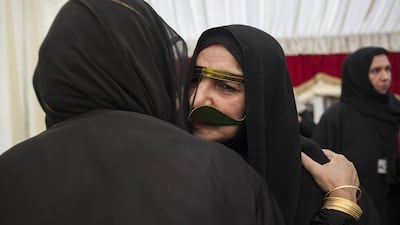 Umm Tariq Al Shehi is greeted by women upon arriving at an event to honour mothers of UAE soldiers killed during service. Razan Alzayani for The National