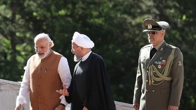 Indian prime minister Narendra Modi, left, walks with Iranian president Hassan Rouhani during a welcoming ceremony at the Saadabad Palace in Tehran on Monday. Iranian Presidency Office via AP