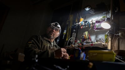 A Ukrainian serviceman works on an FPV drone in a workshop in the Donetsk region. Reuters
