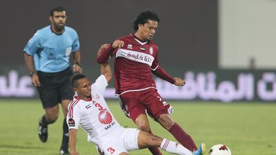 Abdullah Darwish, right, and his Sharjah teammates played Mohammed Al Shehhi and Al Wahda to a draw n Friday night. Al Ittihad