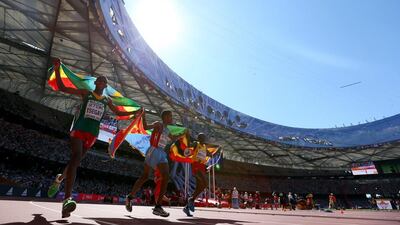Silver-medallist Yemane Tsegay of Ethiopia, gold medallist Ghirmay Ghebreslassie of Eritrea and bronze medallist Munyo Solomon Mutai of Uganda celebrate after crossing the line in the marathon on Saturday at the 2015 World Championships. Alexander Hassenstein / Getty Images