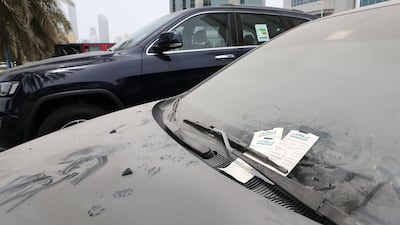 Dirty cars parked in the same spot for more than three days are assumed abandoned and are fined and impounded. Pawan Singh / The National