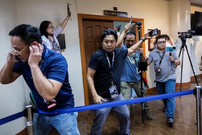 Members of the media react after hearing the gunshots at the Senate. Reuters