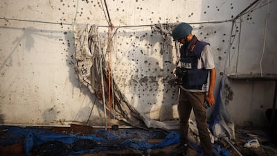 A Palestinian journalist checks the destroyed Al Jazeera tent at Al Shifa Hospital in Gaza City in August, following an overnight strike by the Israeli military. Getty