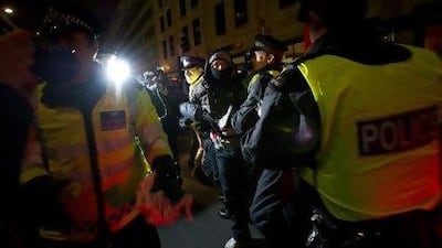 A demonstrator being arrested in central London last Thursday during a protest against the British government's plans to raise university fees. While the unrest raged on, a group of "hacktivists" was busy targeting banks and credit-card companies in the wake of Julian Assange's arrest.