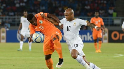 Ghana midfielder Andre Ayew, right, challenges Ivory Coast defender Serge Aurier during the Africa Cup of Nations final on Sunday night. Khaled Desouki / AFP