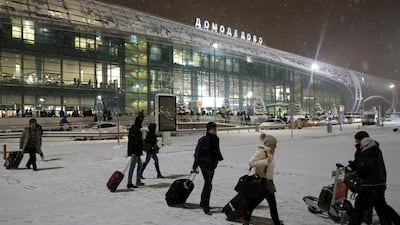 Russian passengers walk outside of the Domodedovo airport terminal in the Moscow region, Russia. Yuri Kochetkov / EPA