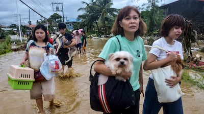 Residents evacuate from their inundated homes in Liloan town, Cebu province. AFP