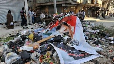 A poster of Syrian president Bashar Al Assad lies on a pile of garbage in the northern city of Aleppo, which has become a new front in the uprising.