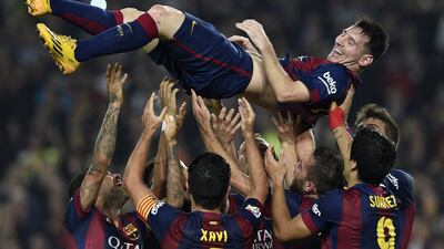 Barcelona's Lionel Messi is thrown into the air by his teammates. AFP