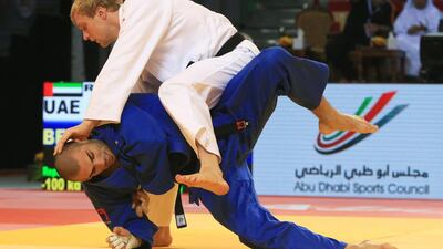 UAE’s Ivan Remarenco, top, tussles with Toma Nikiforov of Belgium during the quarter-finals of the 100-kilogramme category at the IJF Abu Dhabi Grand Slam on Sunday. Ravindranath K / The National