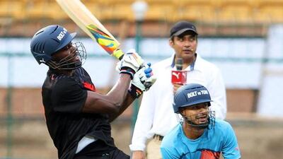 Usain Bolt plays a shot during the exhibition match, formally between Team Usain Bolt and Team Yuvraj Singh, in Bangalore on Tuesday. Jagadeesh NV / EPA
