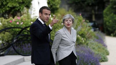 French President Emmanuel Macron, left, and Britain's Prime Minister Theresa May arrive for a joint press conference after a meeting, at the Elysee Palace, in Paris, Tuesday, June 13, 2017. After their talks, the two leaders will watch a France-England football match at the Stade de France that will honor victims of extremist attacks in both countries. (AP Photo/Thibault Camus)