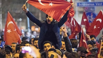 People wave Turkish national flags during a demostration near the Turkish consulate in Rotterdam. Marten van Dijl / AFP Photo