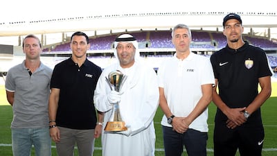 From left: Craig Henderson, Nicolas Burdisso, Mohammed Al Qubaisi, Hernan Crespo and Ismail Ahmed pose with the Fifa Club World Cup at the Hazza Bin Zayed Stadium in Al Ain. Satish Kumar for The National