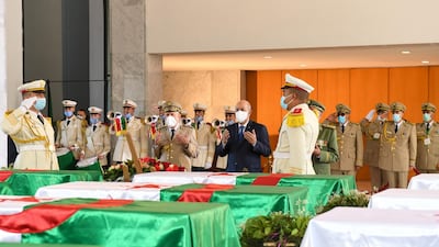 Algeria's President Abdelmajid Tebboune prays during a ceremony to lay to rest the remains of 24 resistance fighters, returned from Paris. AFP